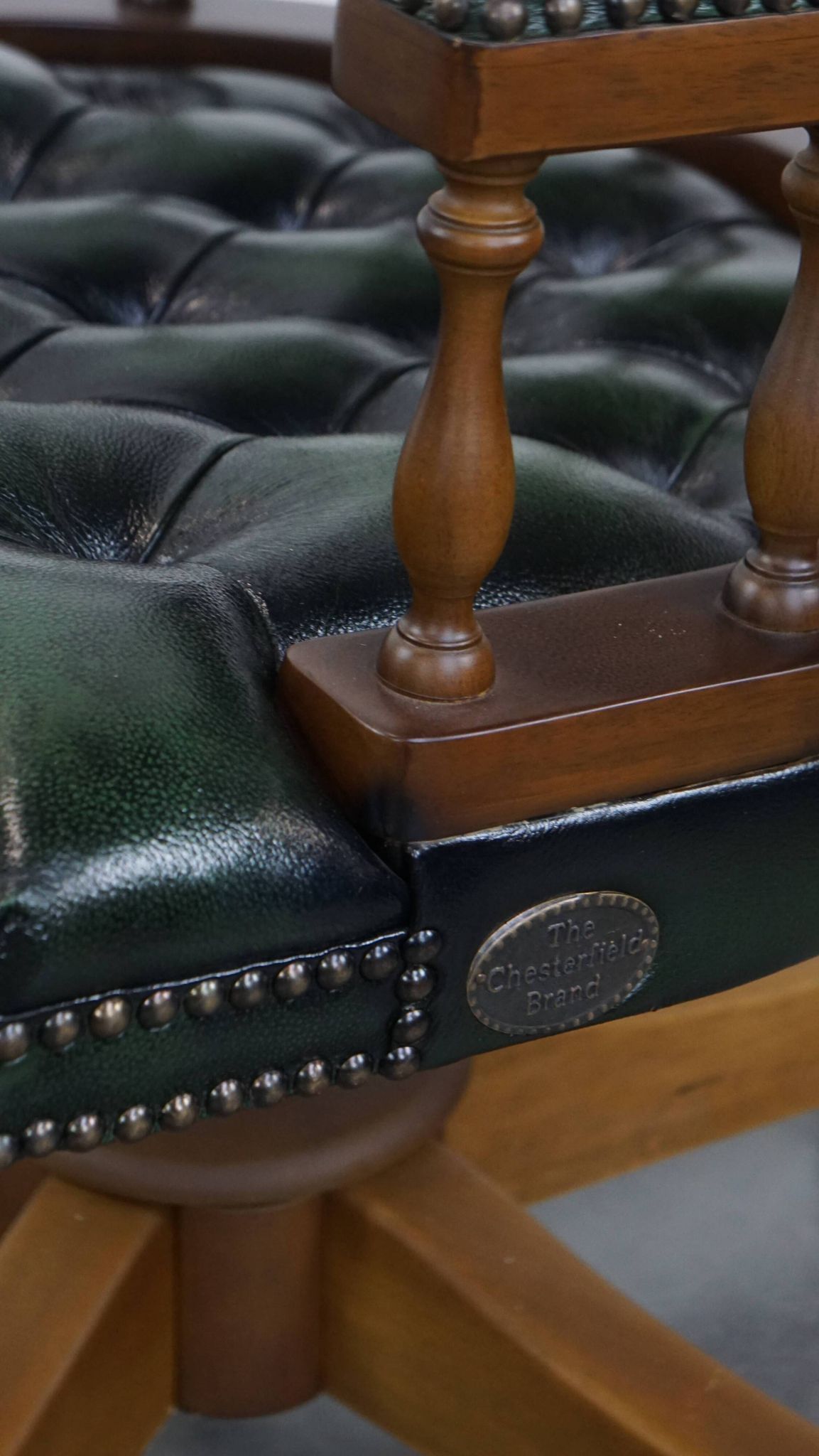 Dark green cowhide leather and wood chesterfield office chair on wheels