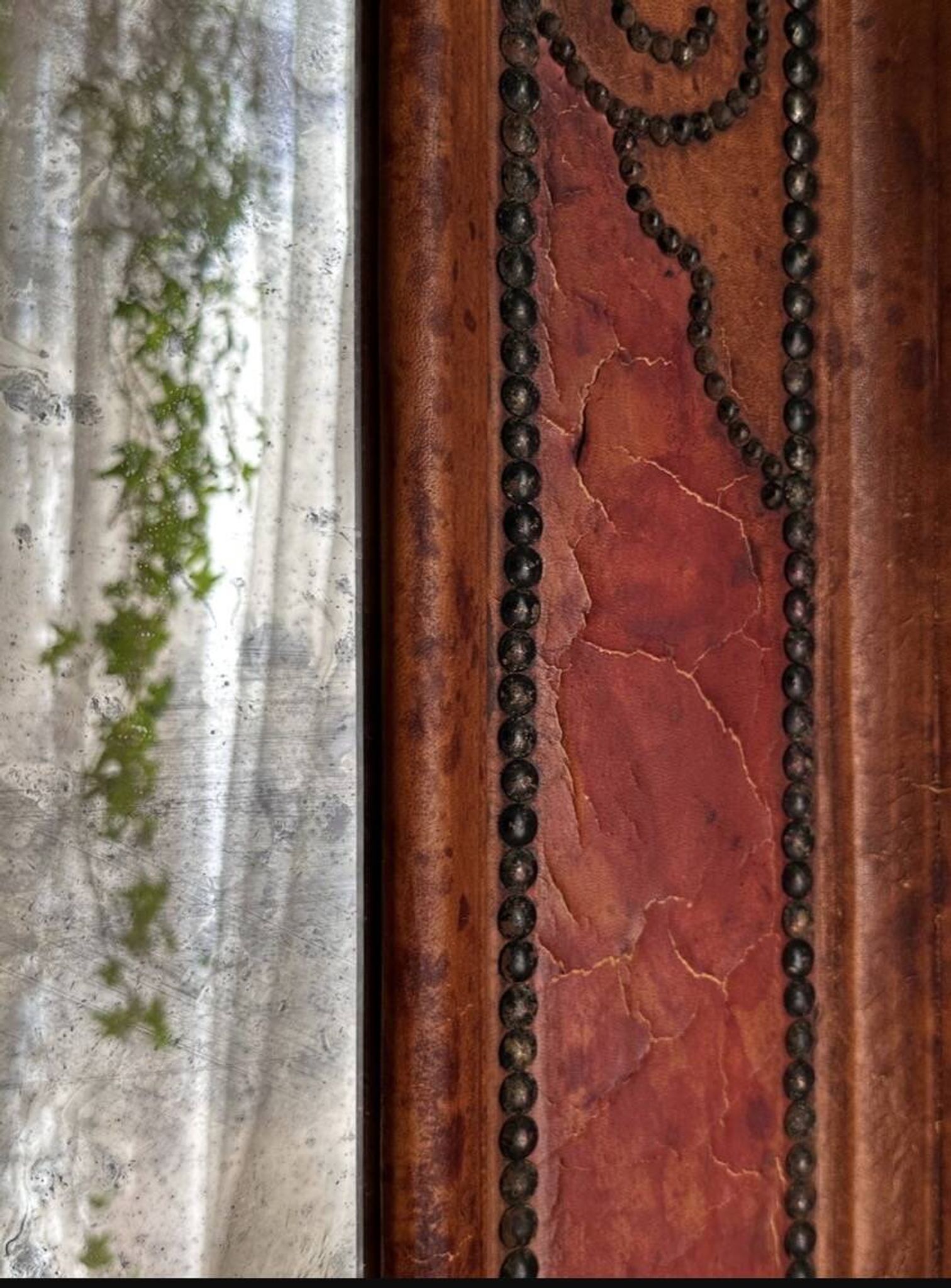 Antique mirror designed by "Pierre Lottier". Leather and nails. France 1