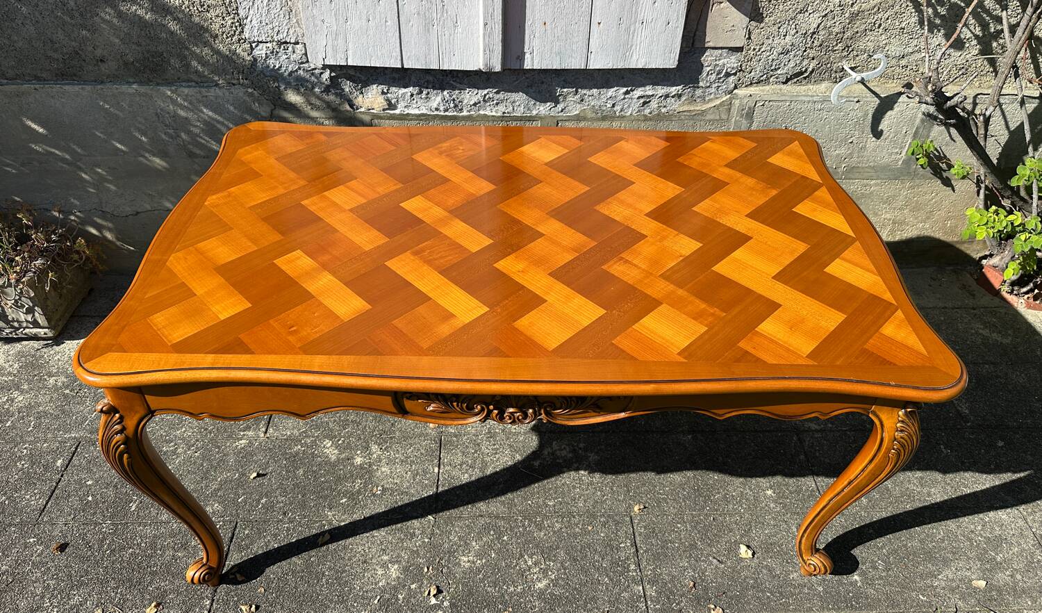 Antique extendable table in cherry wood and marquetry in the Louis XV style.