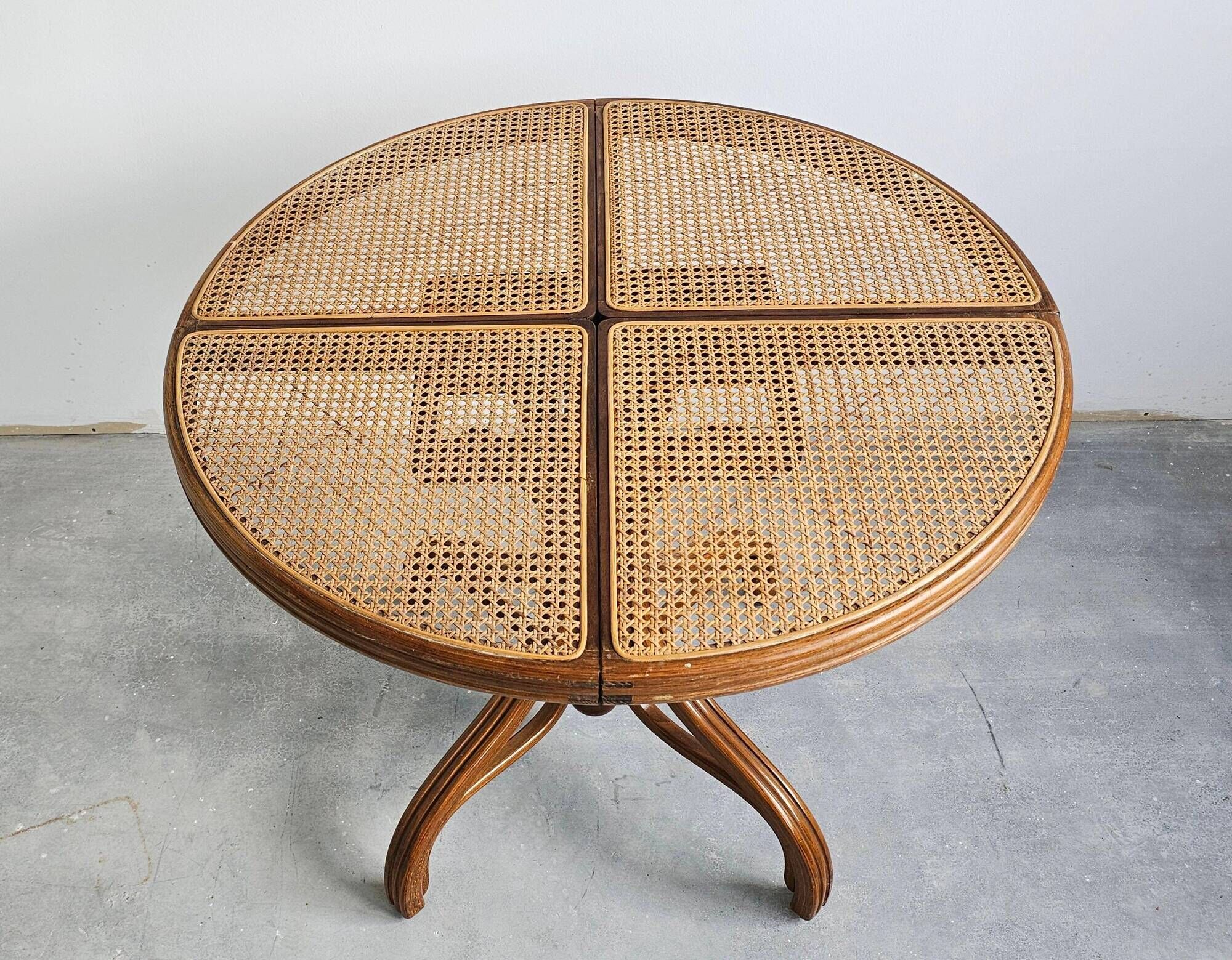 Round dining table in curved wood with a rattan top by Mundus, 1960s.