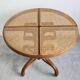 Round dining table in curved wood with a rattan top by Mundus, 1960s.