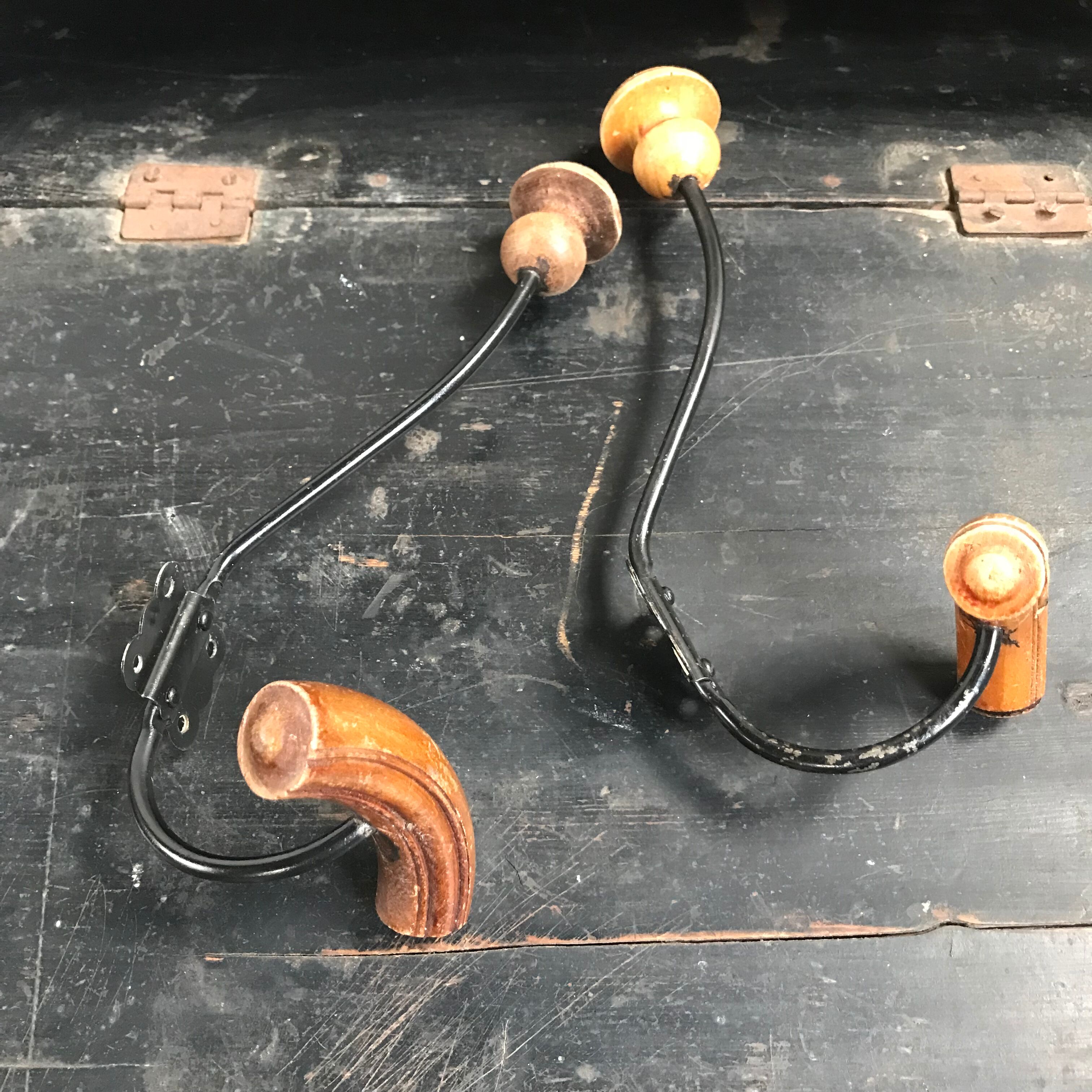 Pair of old wood and metal hooks