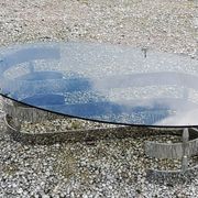 Oval coffee table of the 70s chromed metal base in s smoked glass top