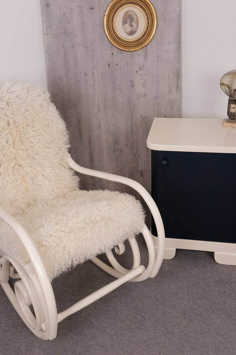 Antique Thonet rocking chair in ivory lacquered bent wood, with a white lamb fur seat.