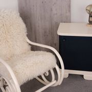 Antique Thonet rocking chair in ivory lacquered bent wood, with a white lamb fur seat.