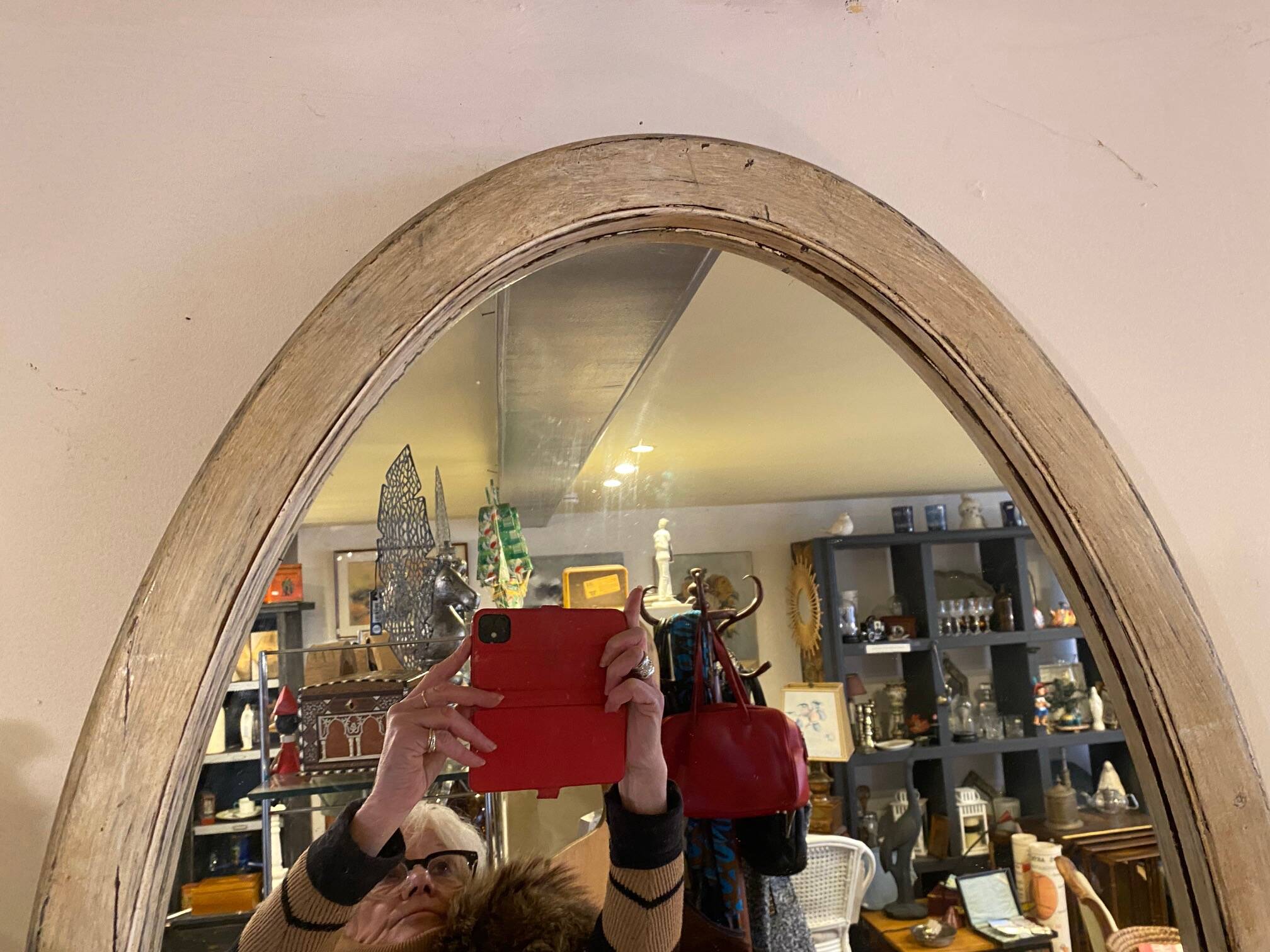 Large old oval mirror with beige patina wooden frame early 20th century