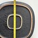 Large decorative ceramic catchall with red and black spiral pattern.