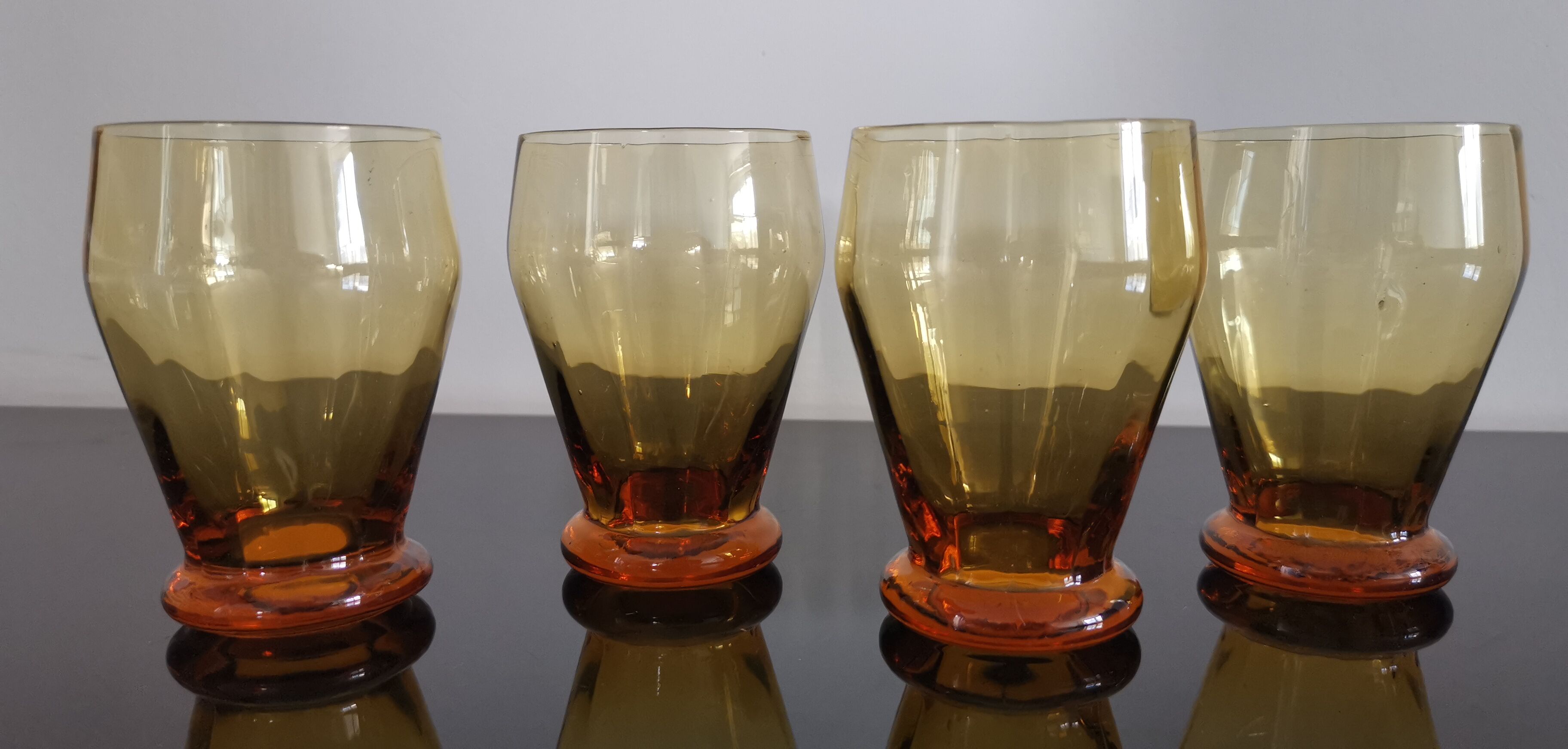 4 old amber colored glasses