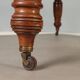 Antique extendable mahogany table with a crank mechanism, United Kingdom.