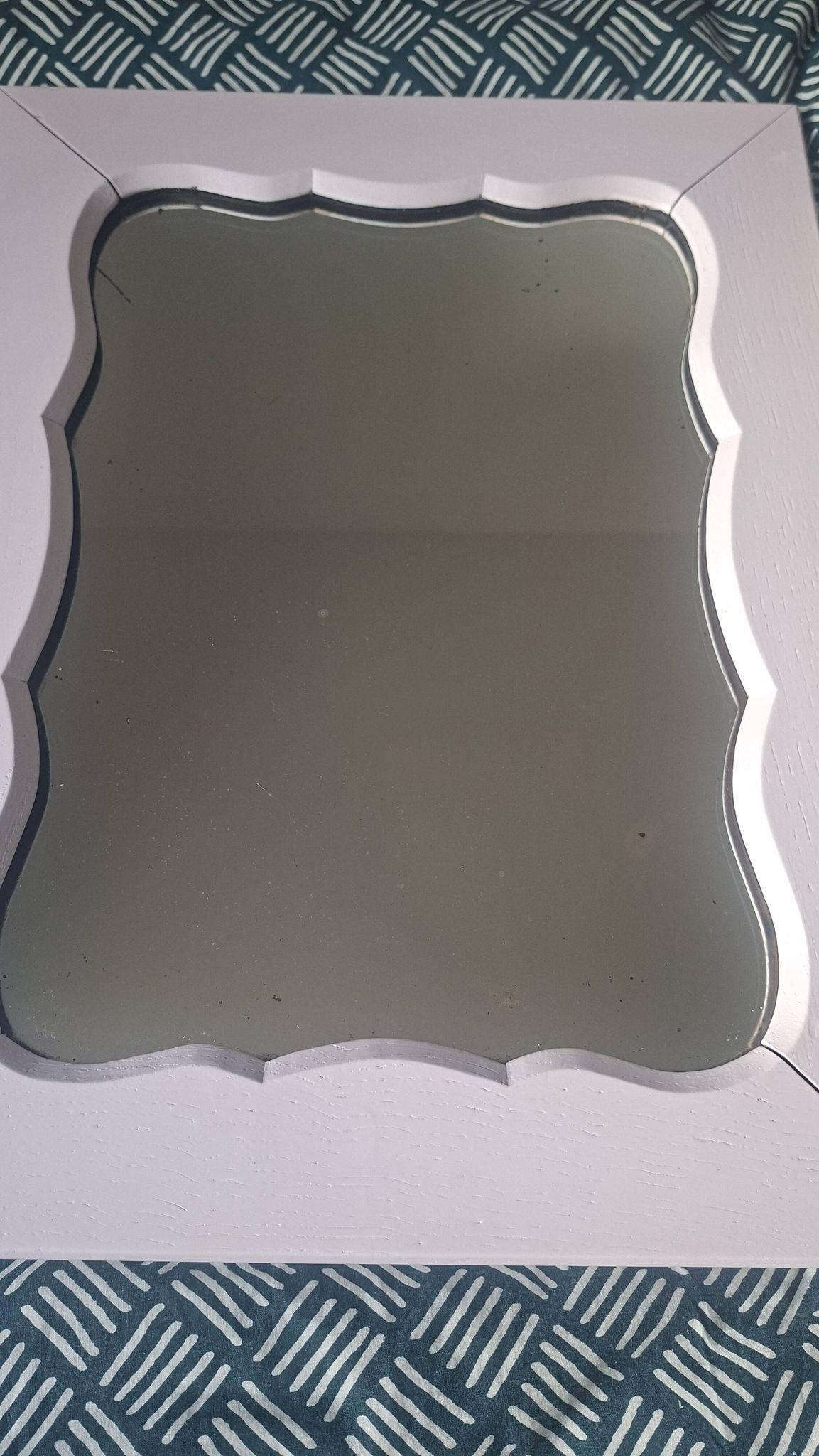 Mid-20th century rectangular wall mirror with a powder pink frame.