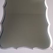 Mid-20th century rectangular wall mirror with a powder pink frame.