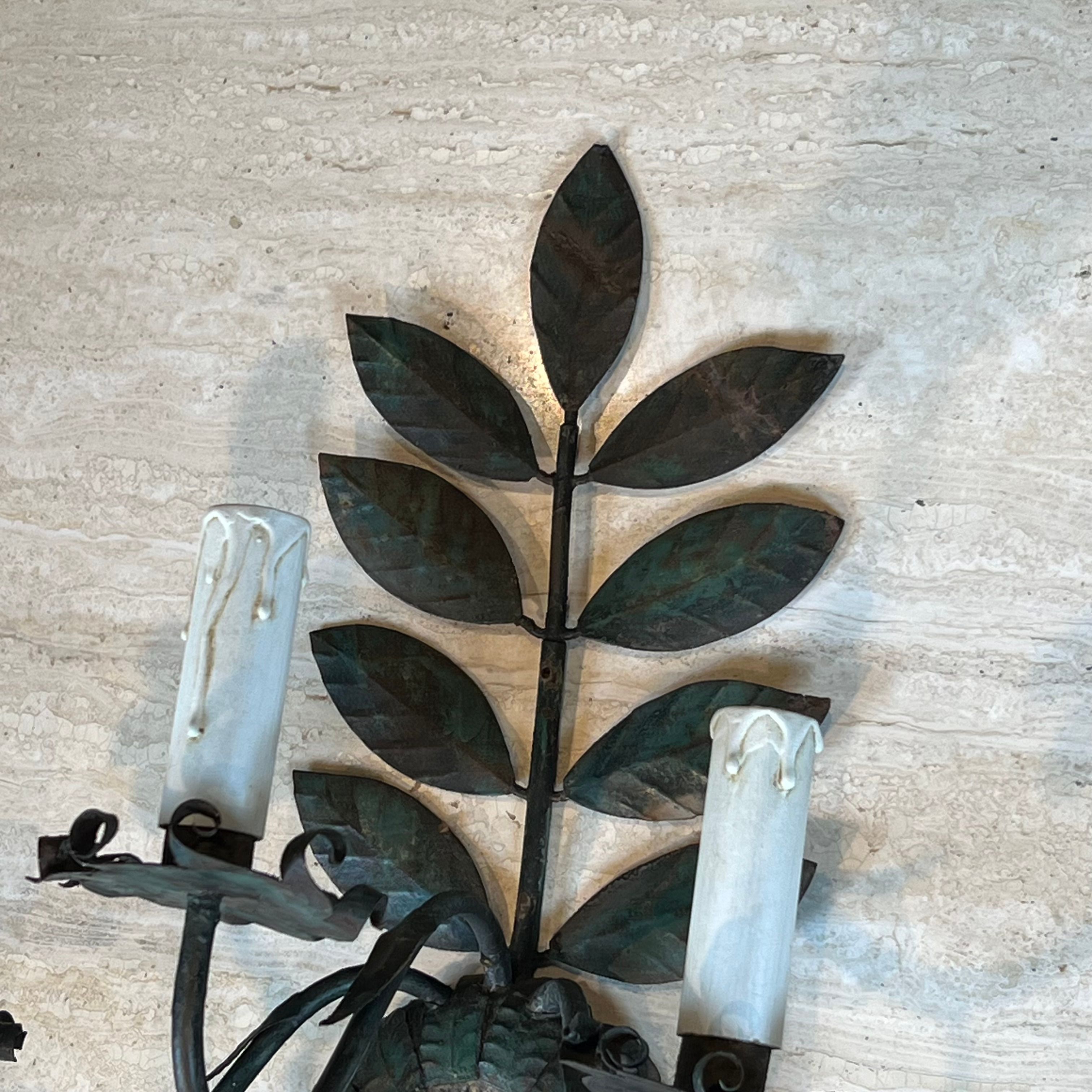 Pair of decorative wall sconces with sunflowers and patinated metal foliage.