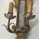 Pair of wall sconces in carved wood and silvered and gilded patinated metal with a central mirror.