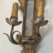 Pair of wall sconces in carved wood and silvered and gilded patinated metal with a central mirror.