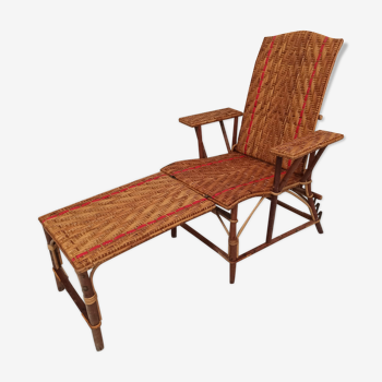 Sunbathing sunbathing in wicker rattan wood deckchair red lounger