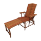 Sunbathing sunbathing in wicker rattan wood deckchair red lounger
