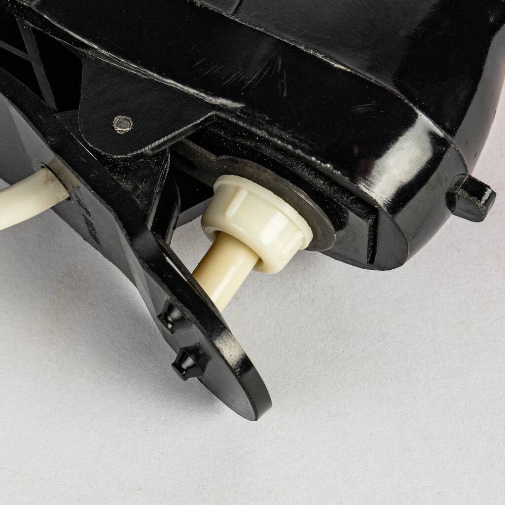 A small, wooden table lamp that stands on a tripod