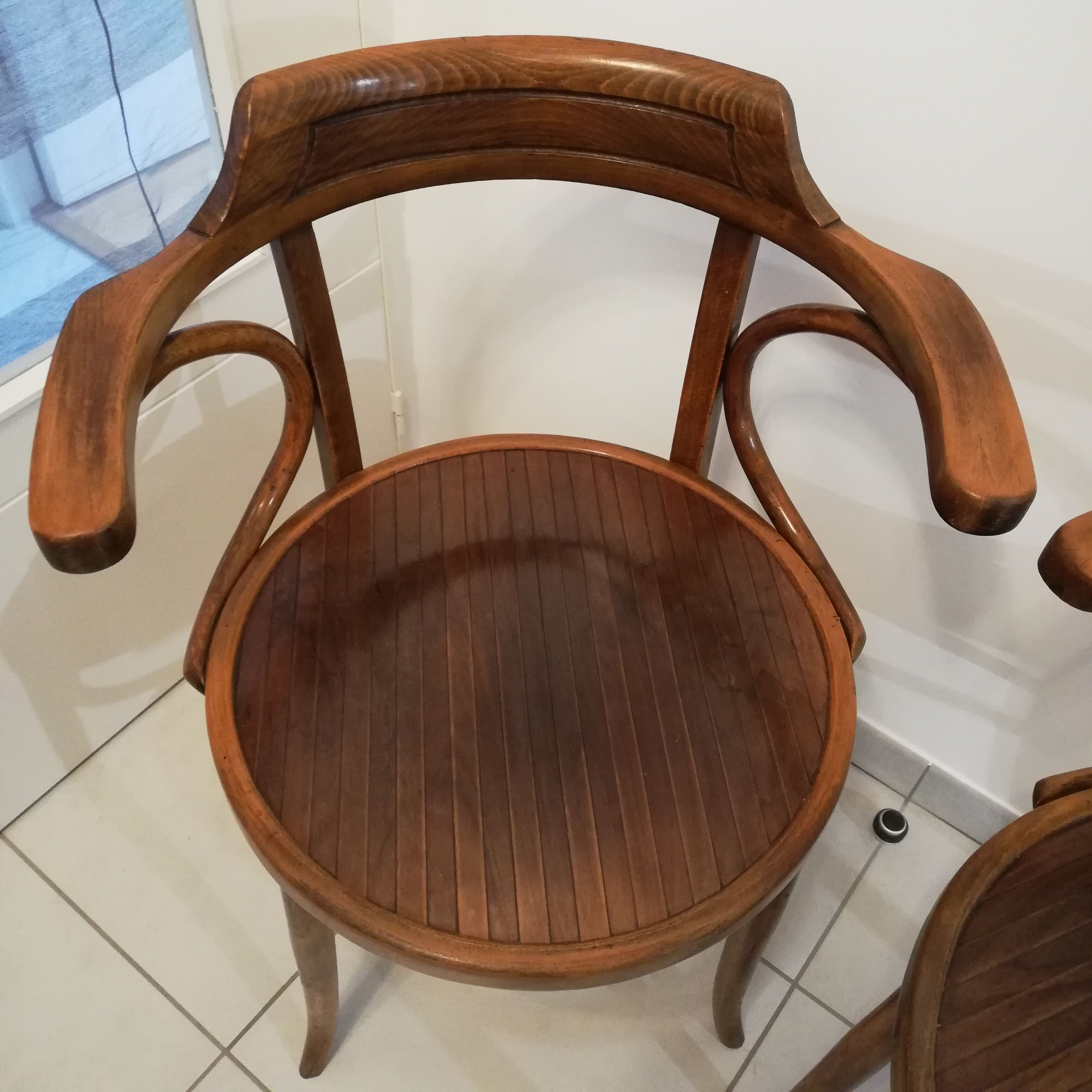 Pair of curved wooden armchairs