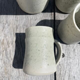 Set in stoneware cups and pitcher