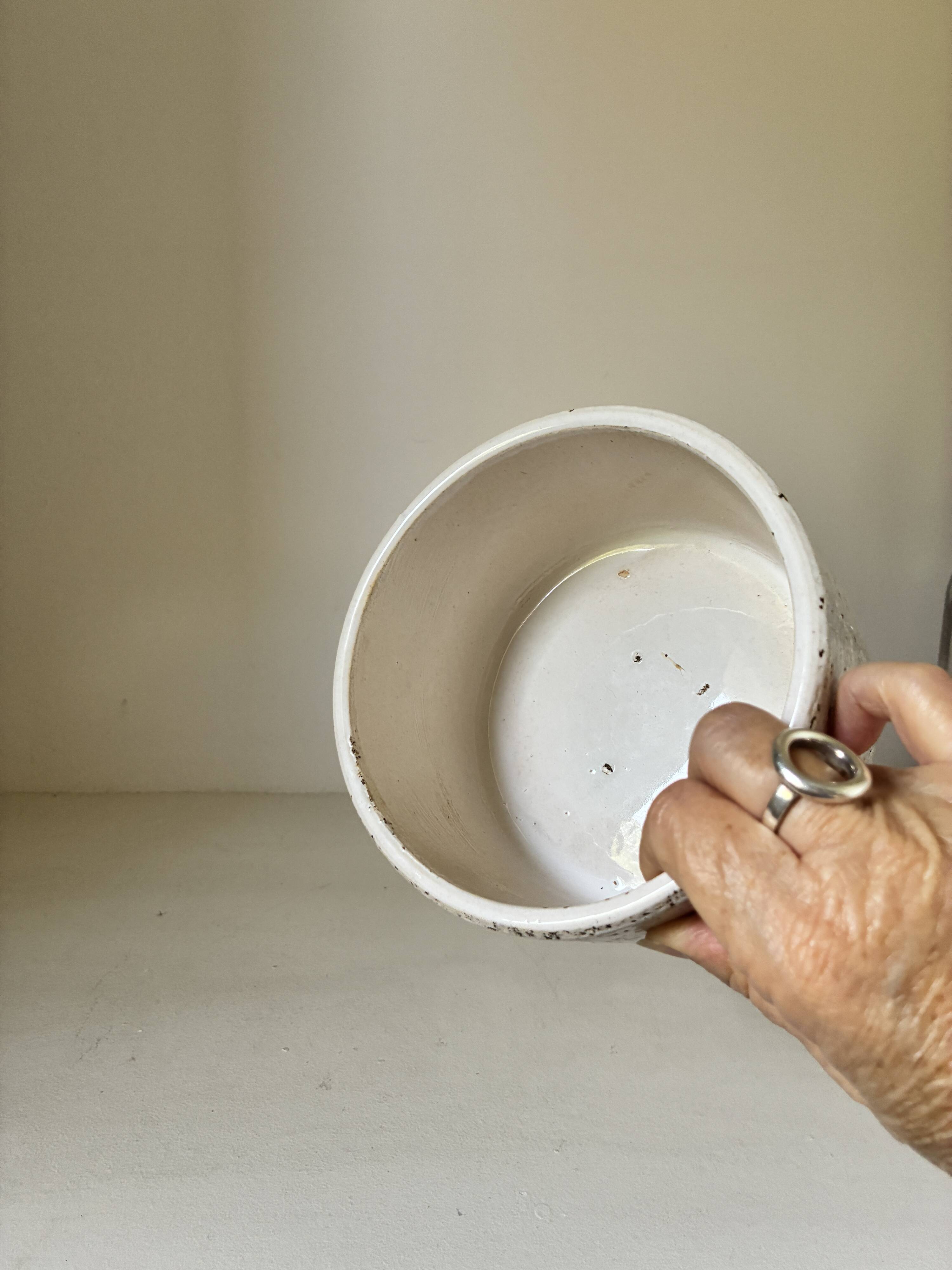 White ceramic vase with a textured effect.