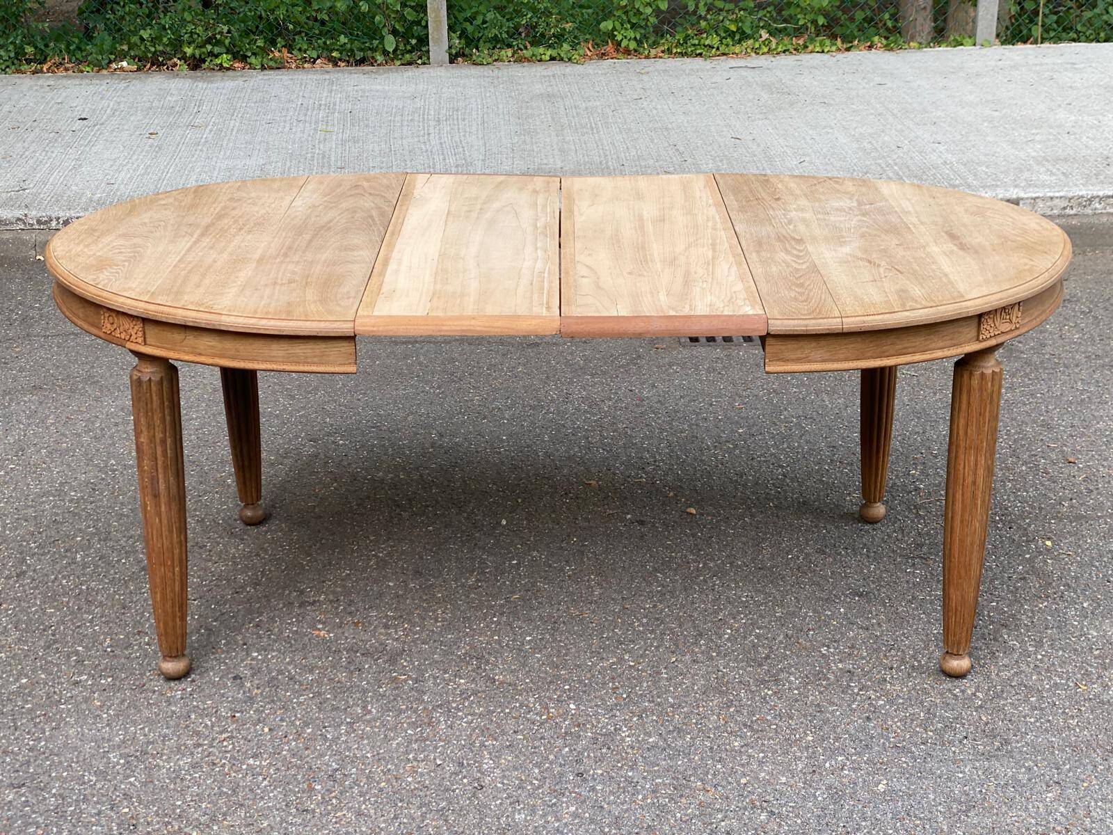 Large stripped solid oak dining table in Louis XVI style with 3 extensions.