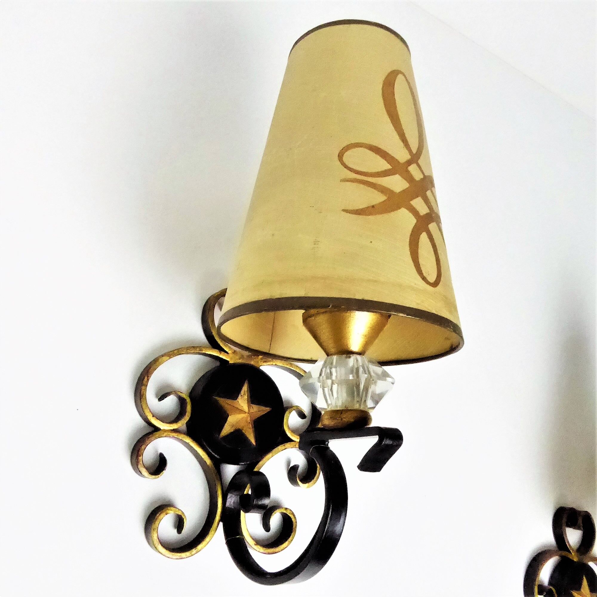 1950 gold star and black metal sconces