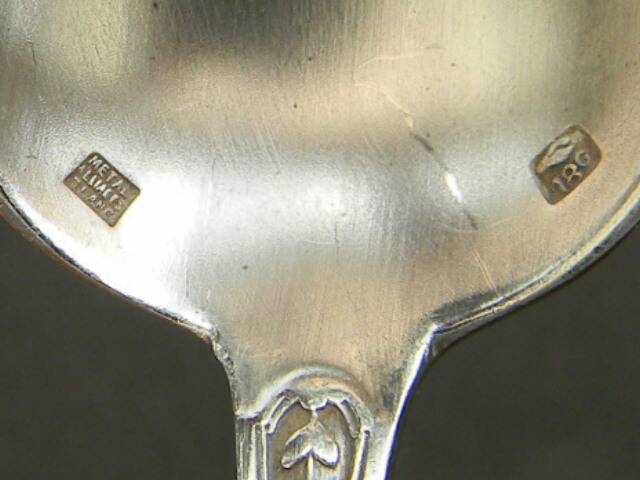 Set of 11 SFAM silver metal teaspoons.