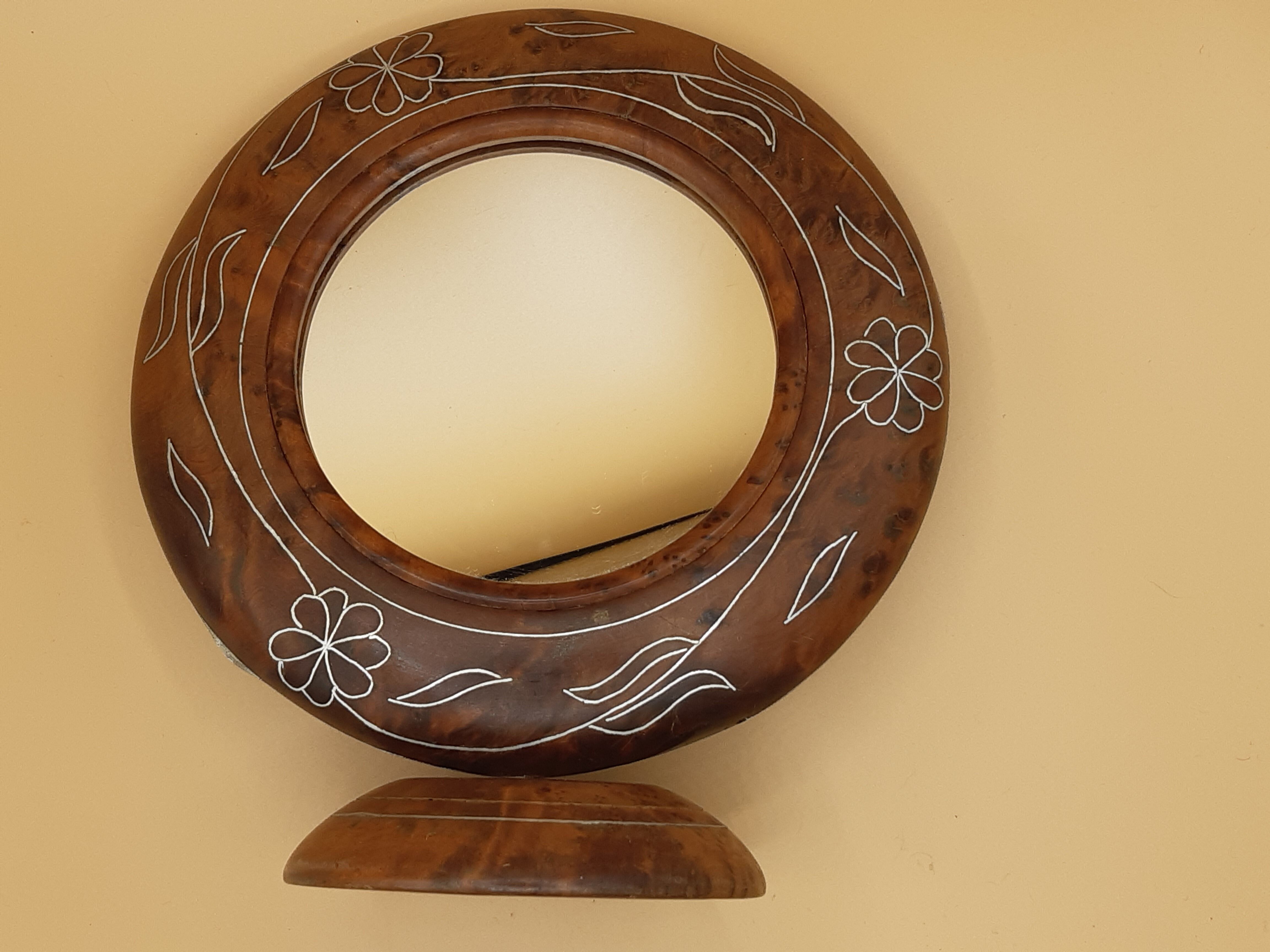 Antique mirror on wooden stand and metal net