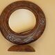 Antique mirror on wooden stand and metal net