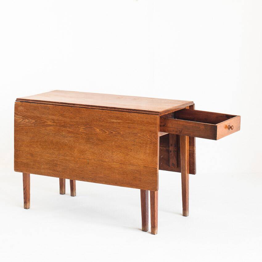Vintage table with two folding leaves. Solid oak wood. France, 1940s