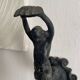 Antique cast iron coat hook with swimmer and shell basin.