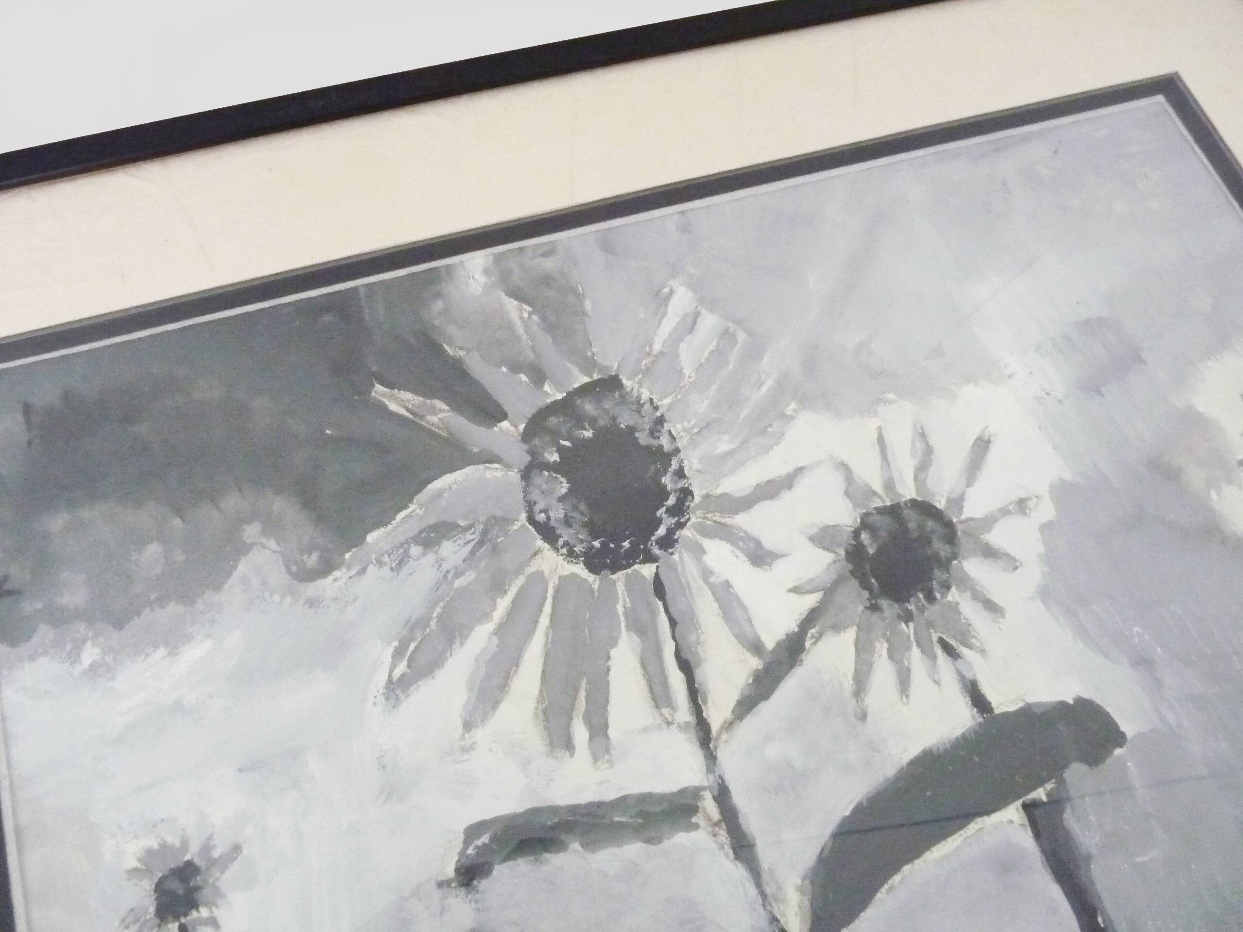 Framed painting with gray flower decor.