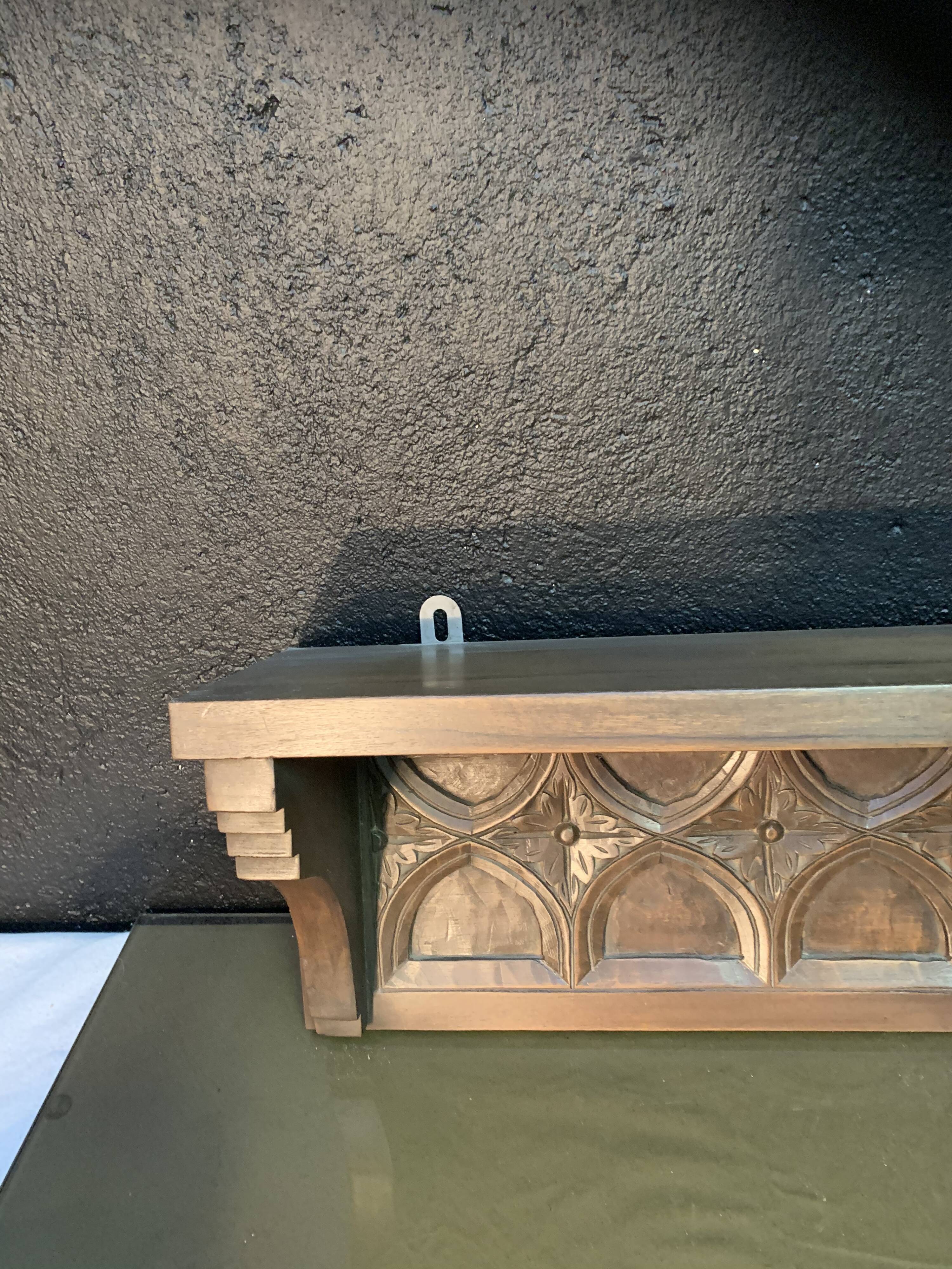 Carved wooden wall shelf