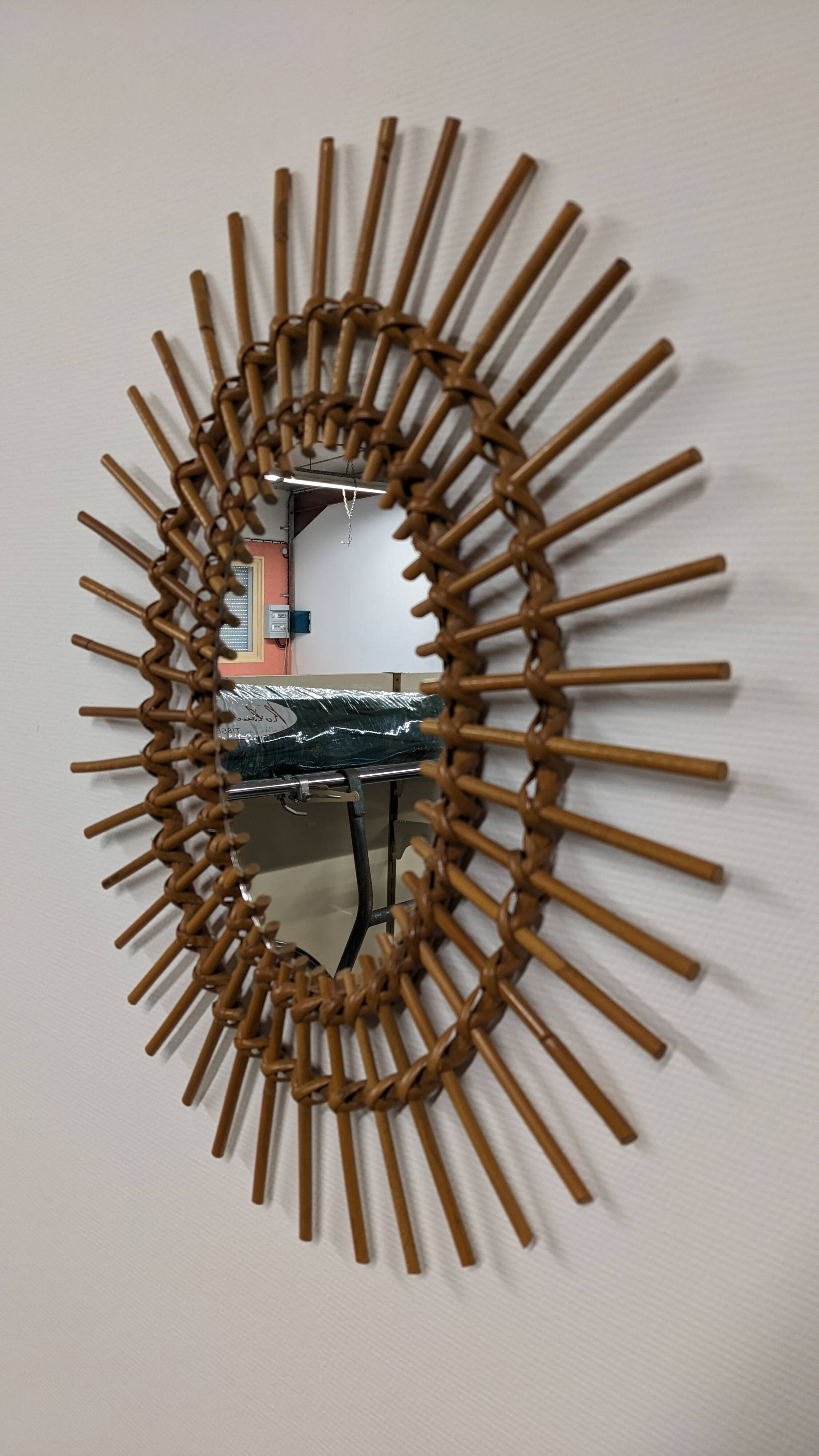 Oval rattan mirror, France circa 1960.