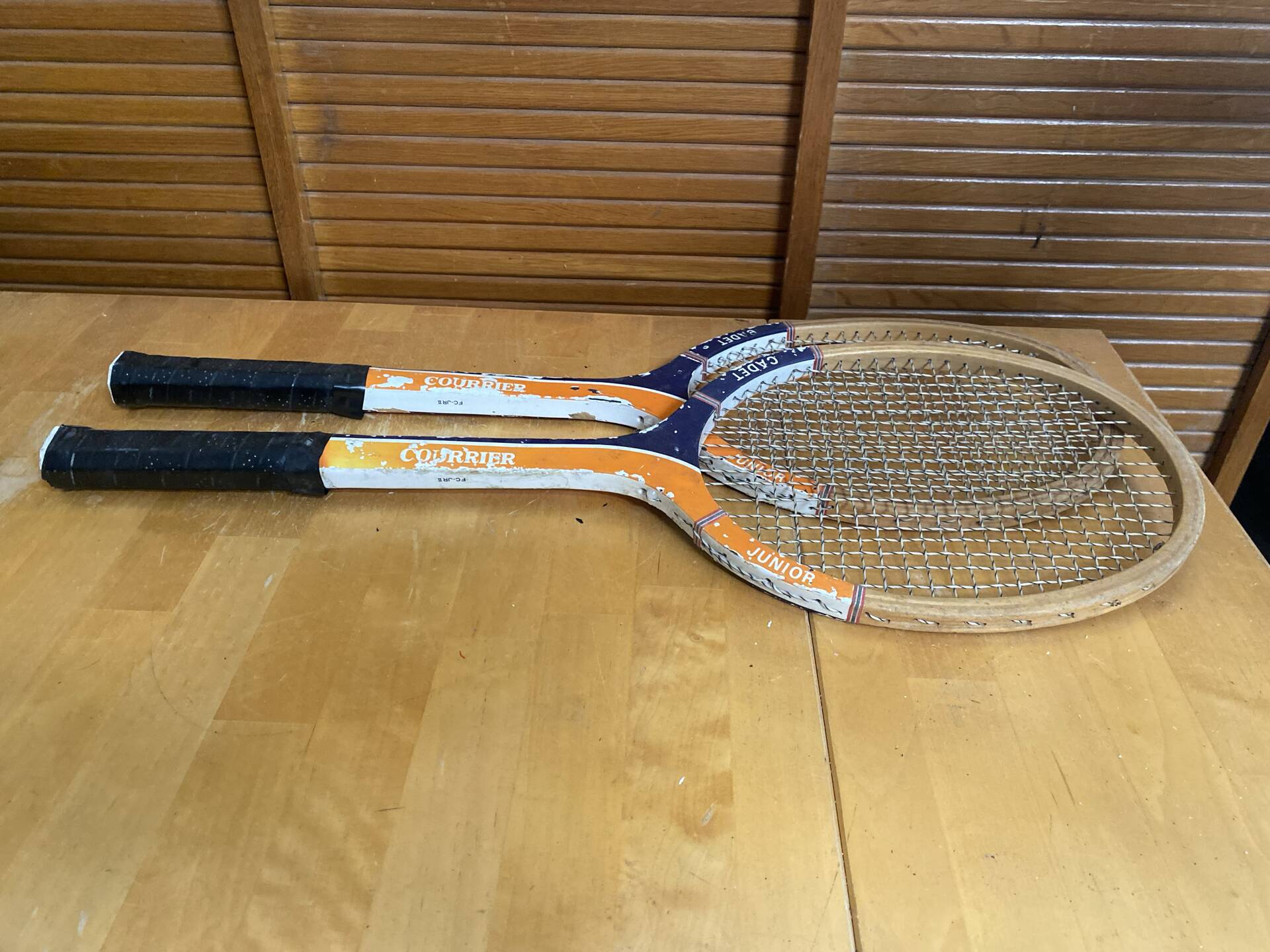 Pair of vintage wooden tennis rackets for cadet junior sport courier