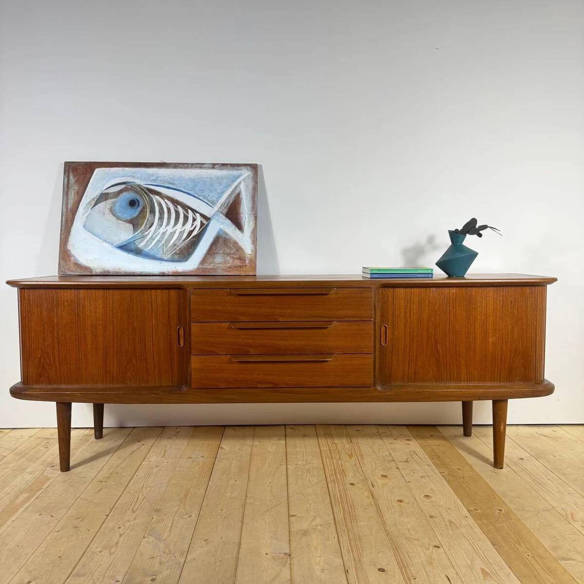 Vintage teak sideboard with rounded edges and sliding doors – mid-century Scandinavian design.