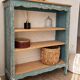 Antique wooden bookshelf with a patinated blue-green finish.