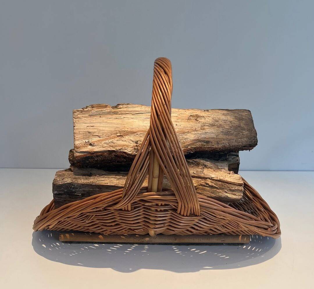Woven Rattan Log Holder in a Semi-Round Shape with a Central Arched Handle.