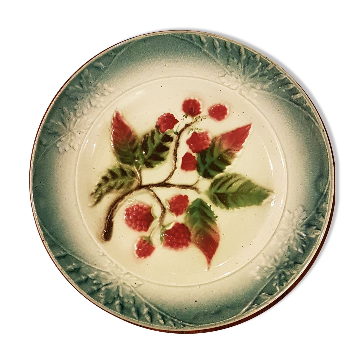 Old plate with decoration of raspberries