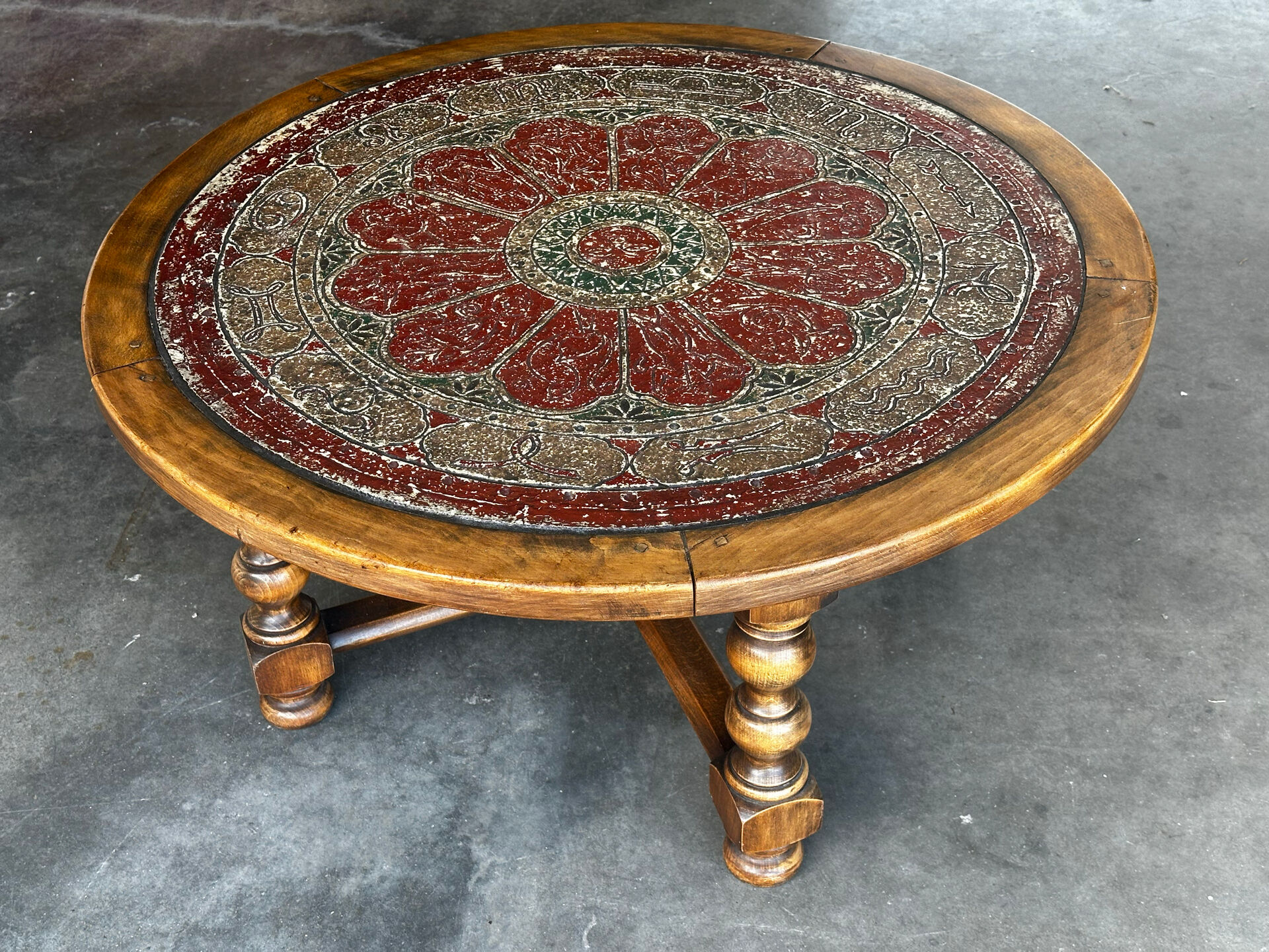 Vintage coffee table in turned wood and leather with astrological decoration.