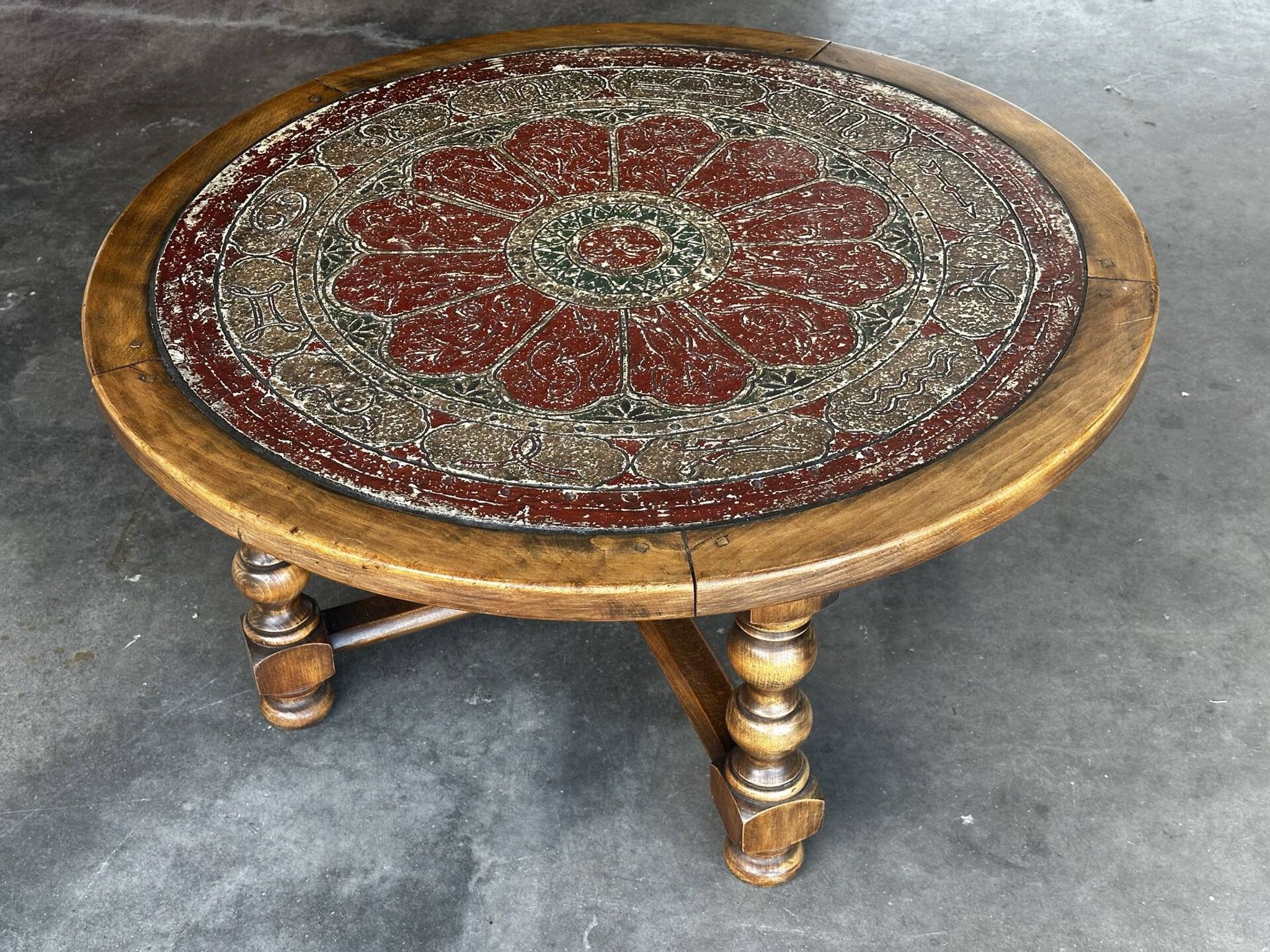 Vintage wooden turned coffee table with leather and astrological decoration.