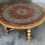 Vintage wooden turned coffee table with leather and astrological decoration.