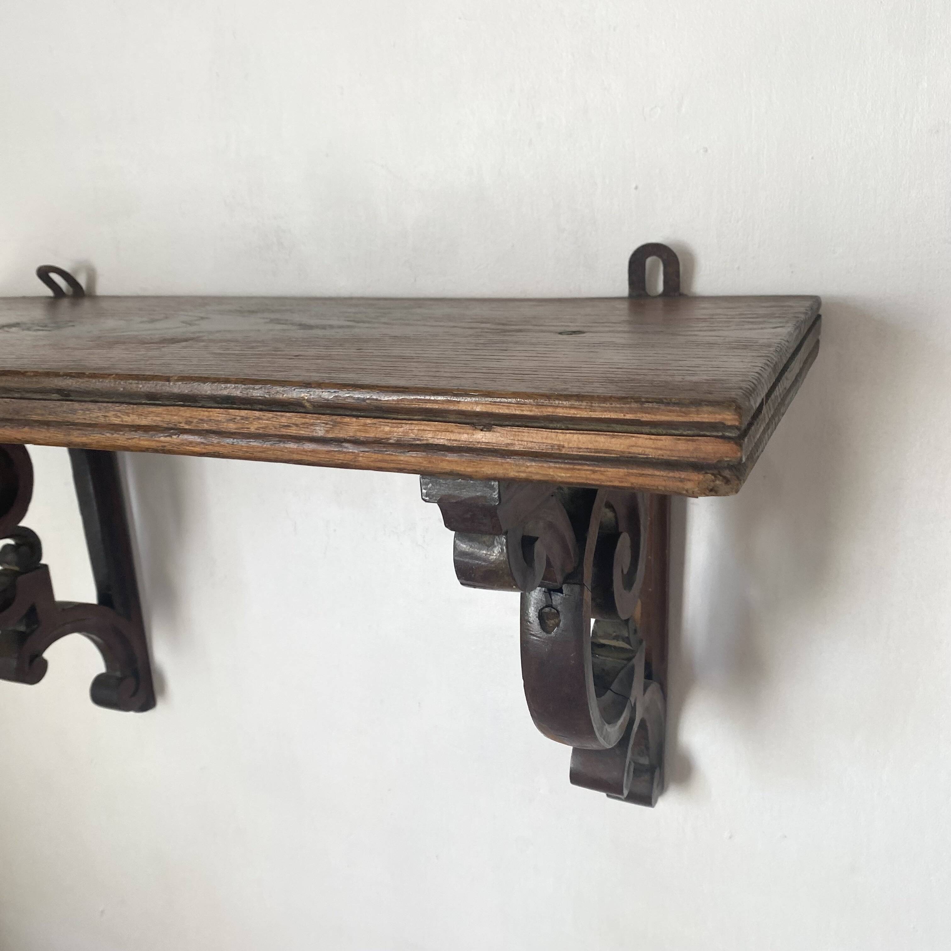 antique oak wall shelf with carved brackets