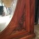 Old oval walnut wood mirror has flower carvings decoration