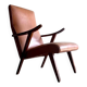 Vintage armchair from the 1950s in cognac leather and dark wood — modernist lounge chair.