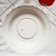 Old mismatched earthenware dinner plates accompanied by a deep dish