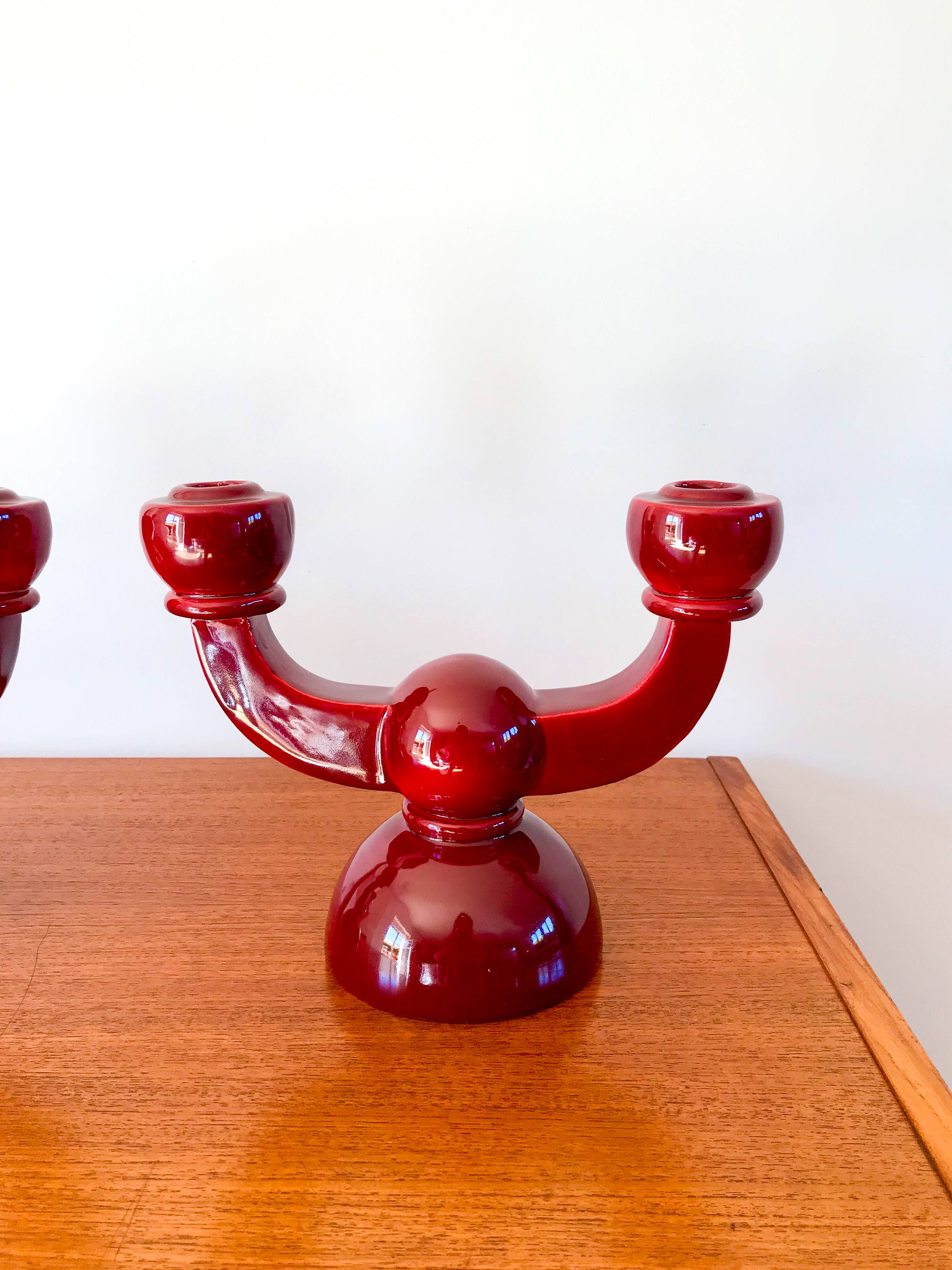 pair of burgundy enameled ceramic candlesticks / candelabras signed 1949