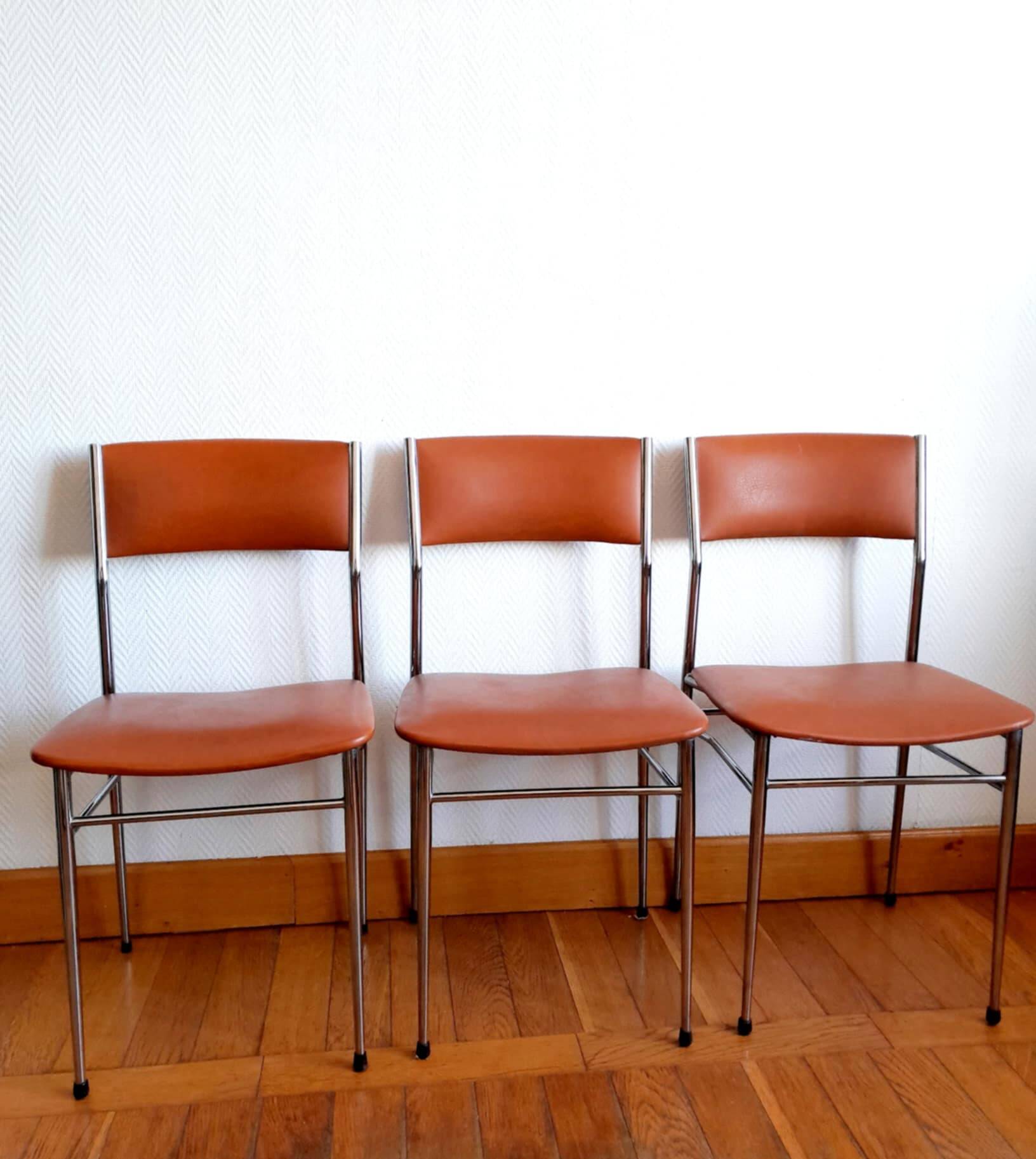 Three mid-century chairs in faux leather and chrome from the 1950s.