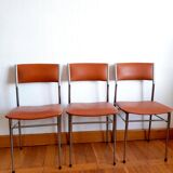 Three mid-century chairs in faux leather and chrome from the 1950s.
