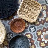 Set of 7 black and natural wicker baskets.